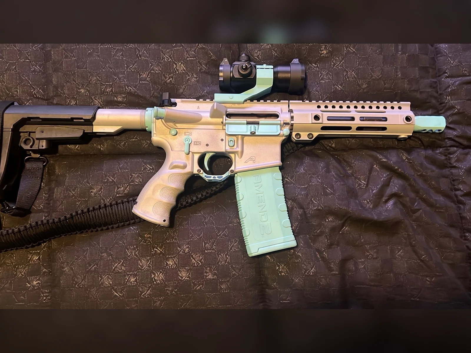 Frostbite custom Cerakote AR-15 with a 7.5-inch barrel in silver with light teal accents and magazine by Tattoo Tactical