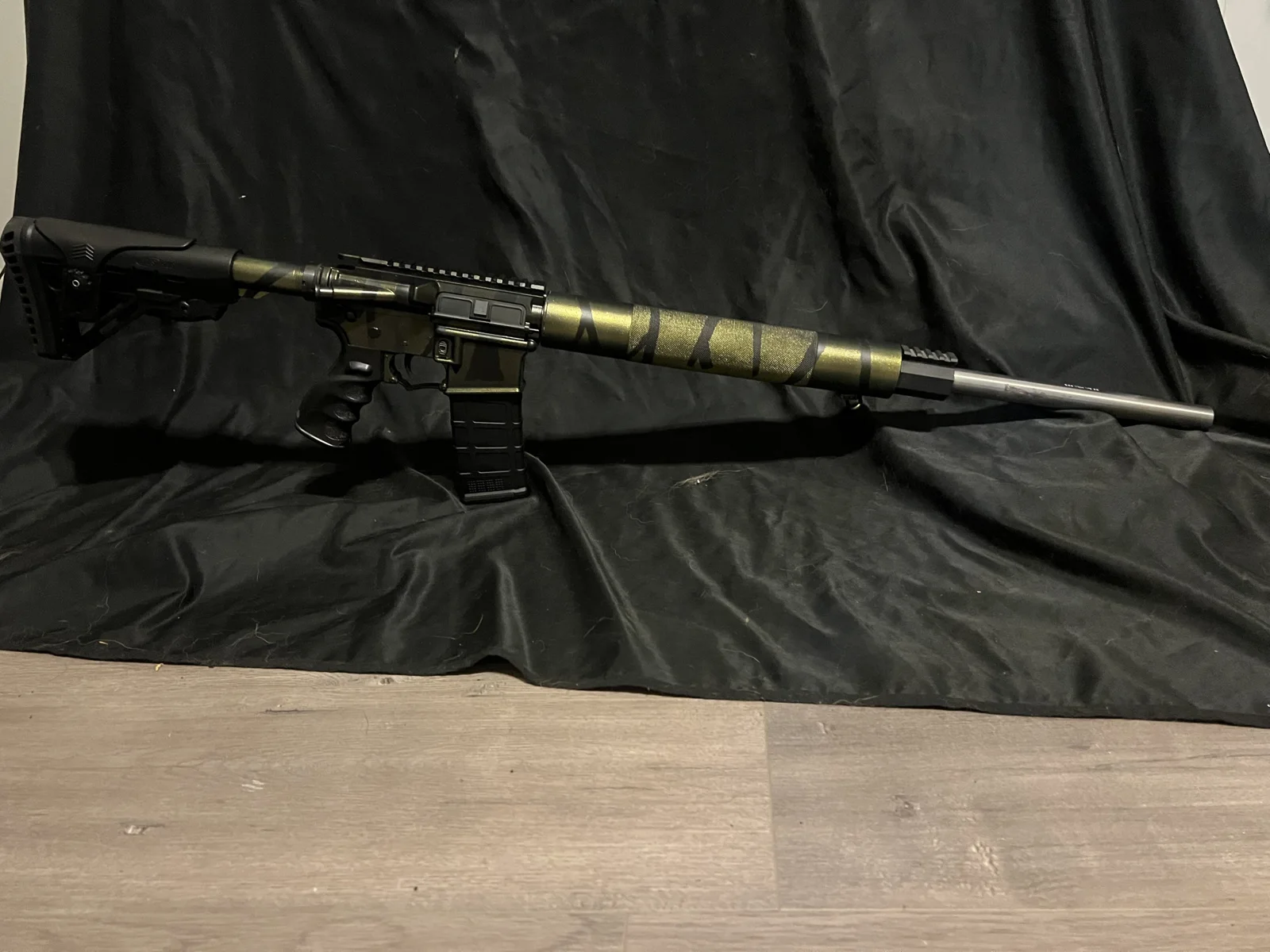 AR-15 rifle with a green and black striped Cerakote finish by Tattoo Tactical