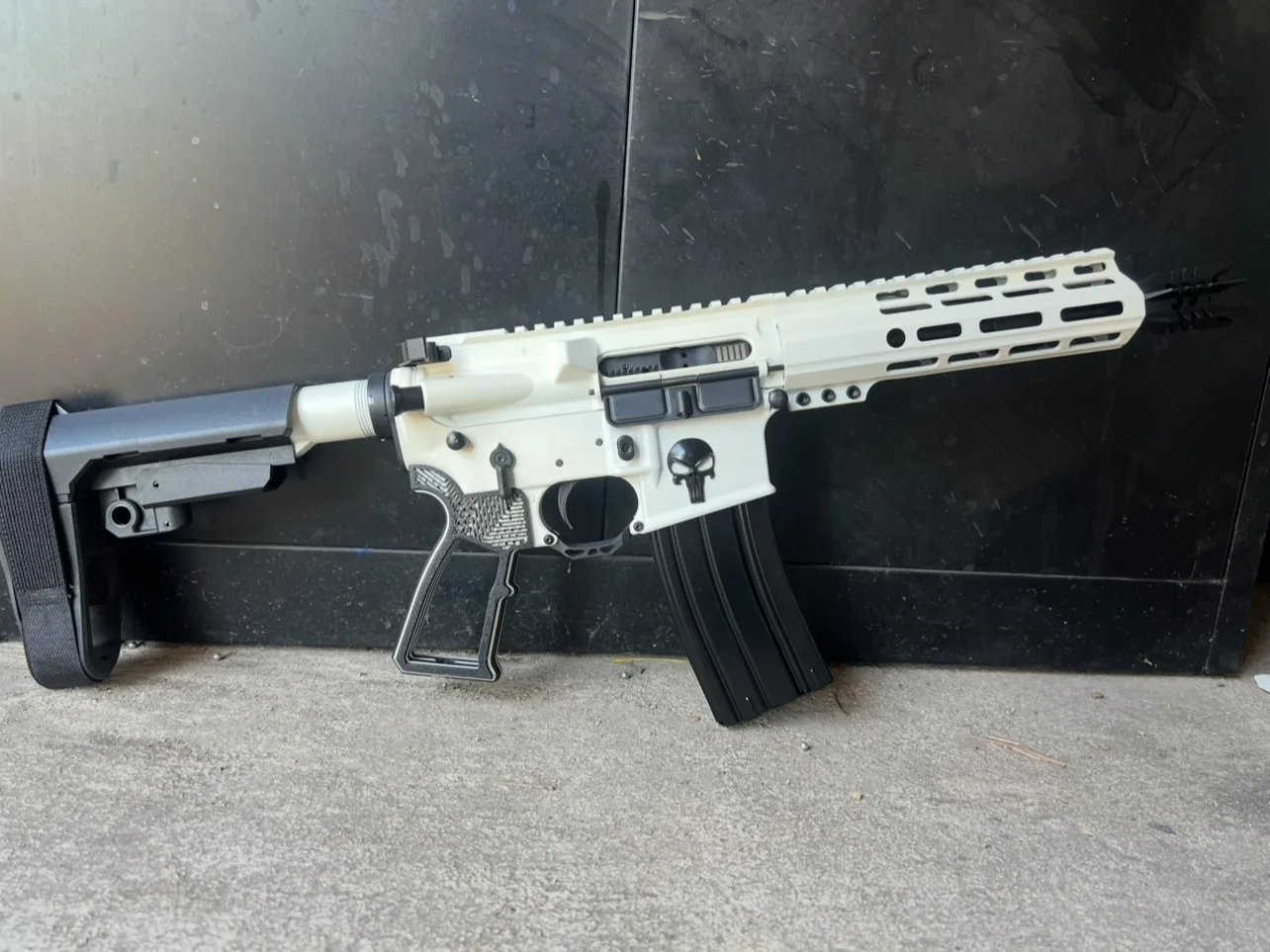 Reverse Punisher custom Cerakote AR-15 in white with a black Punisher skull on the lower receiver by Tattoo Tactical