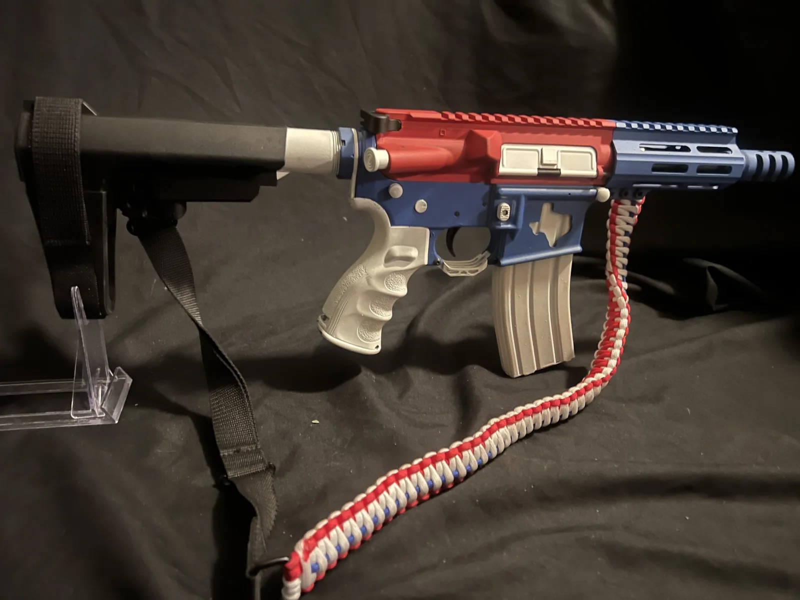 AR-15 pistol in red, white and blue Cerakote with a Texas outline on the lower receiver by Tattoo Tactical